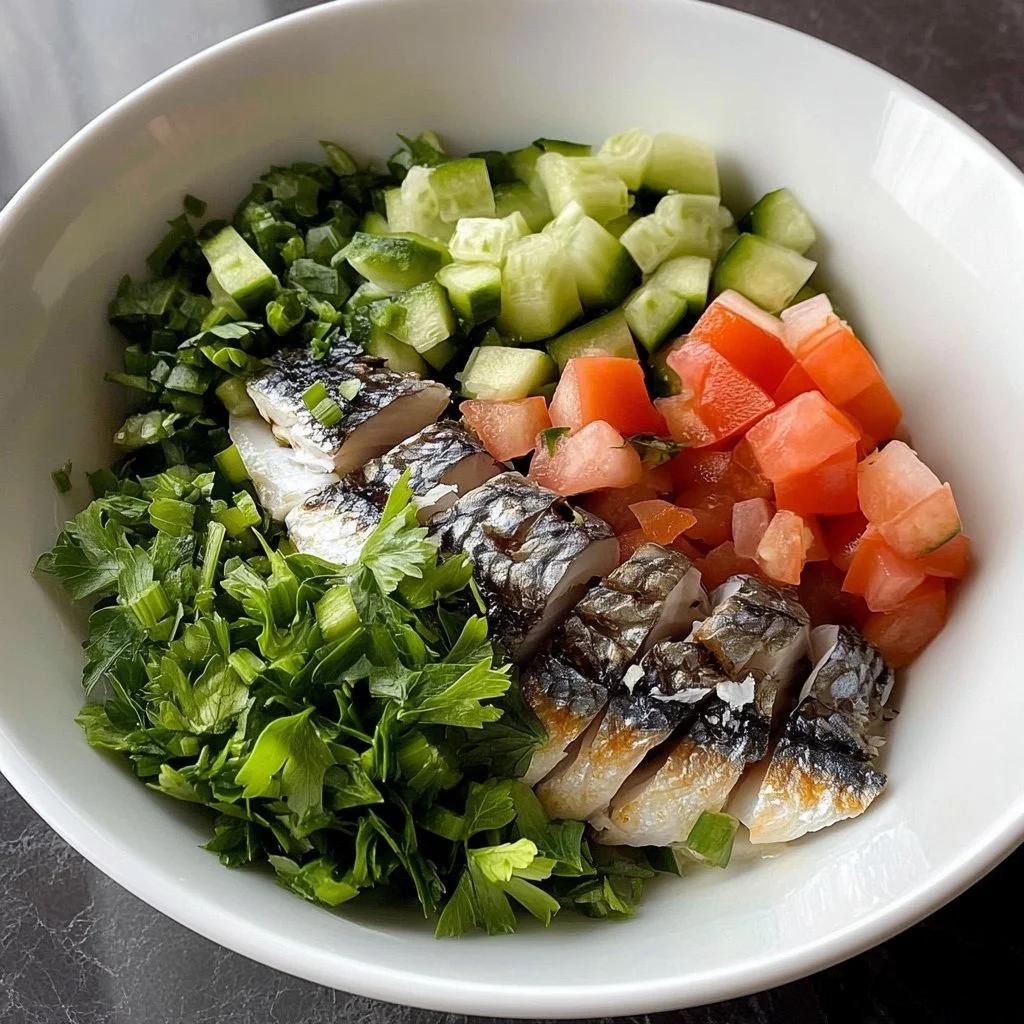A fresh and colorful sardine salad with vegetables and dressing served in a bowl